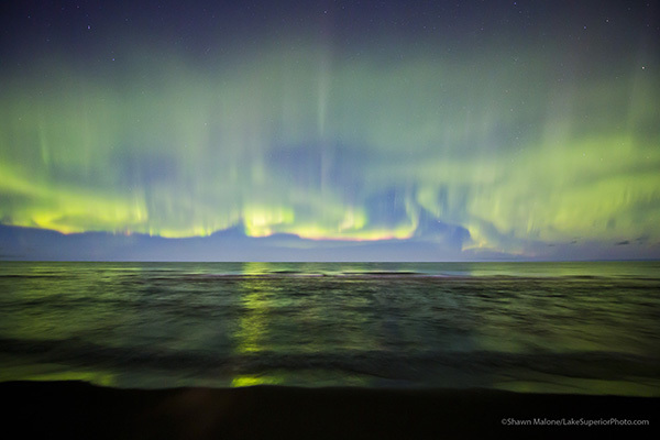 Photo of the Northern Lights over lake by Shawn Malone