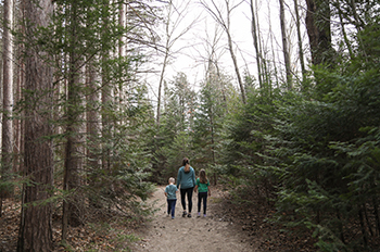 Mother walking with two children on trail