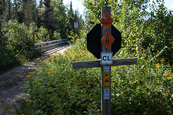 ORV and snowmobile trail signage on the edge of a trail bridge