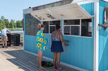 two visitors standing at food concession