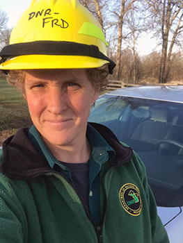 DNR forester Brenda Haskill is shown in her yellow, DNR hard hat.
