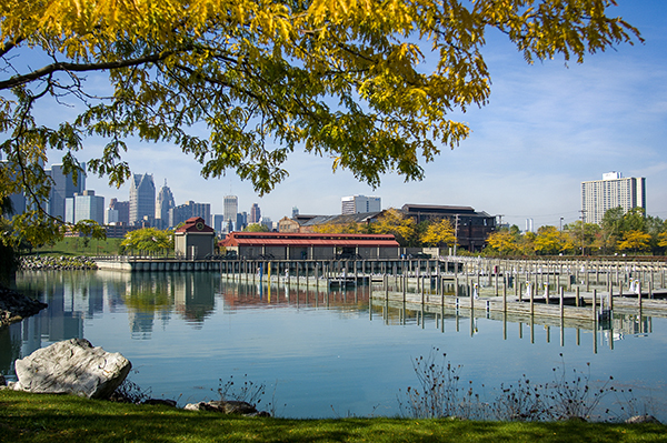 A nice landscape photo shows Detroit and Milliken State Park on a sunny day, with trees visible.