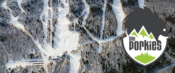 bird's eye view of ski runs and chalet, the porkies logo