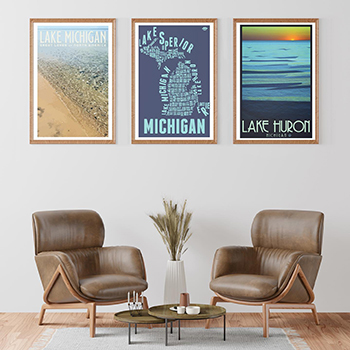 three Michigan-inspired prints hanging above two chairs