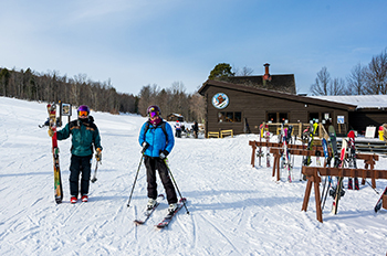 cross-country skiers outside ski lodge