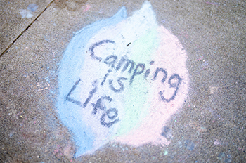 Camping is life chalked on sidewalk