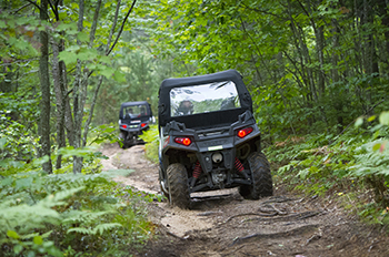 Two ORVs riding trail