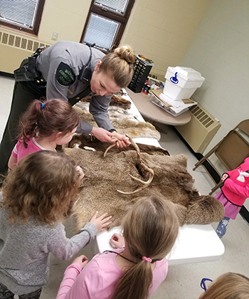 co showing fur kit with young students