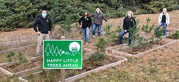 A group is shown at a tree planting in the Lower Peninsula.