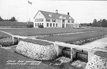 An exterior view of the Thompson State Fish Hatchery is shown from around 1940.