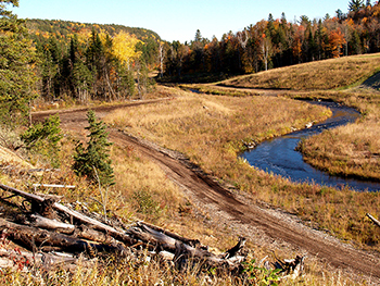 An autumn image shows the restored Dead River watercourse in Marquette County.