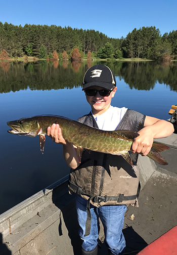 Youth angler holding a muskie