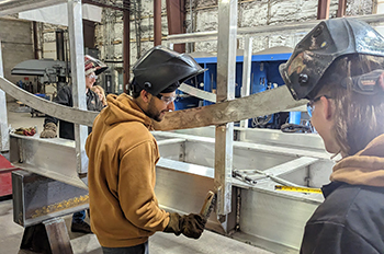 Welding students at work on footbridge for Harrisville State Park