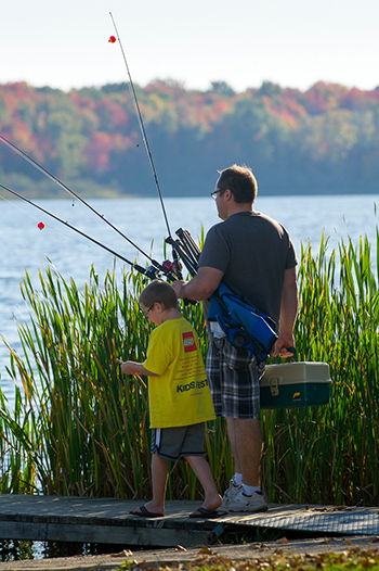 An angler and a youth angler on a doc