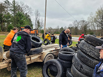 Volunteers remove tires from Michigan state forest lands.