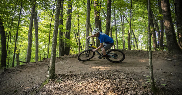 mountain biker on wooded trail