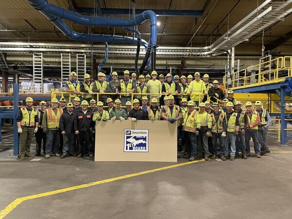 A group photo of factory workers at the Sagola, MI facility that will produce siding