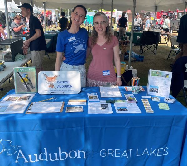 MiBirds Ambassadors standing at Audubon of Great Lakes table at the Blue Water Sturgeon Festival