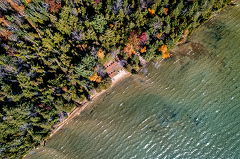 bird's eye view of RAM Center shoreline on Higgins Lake with fall leaves