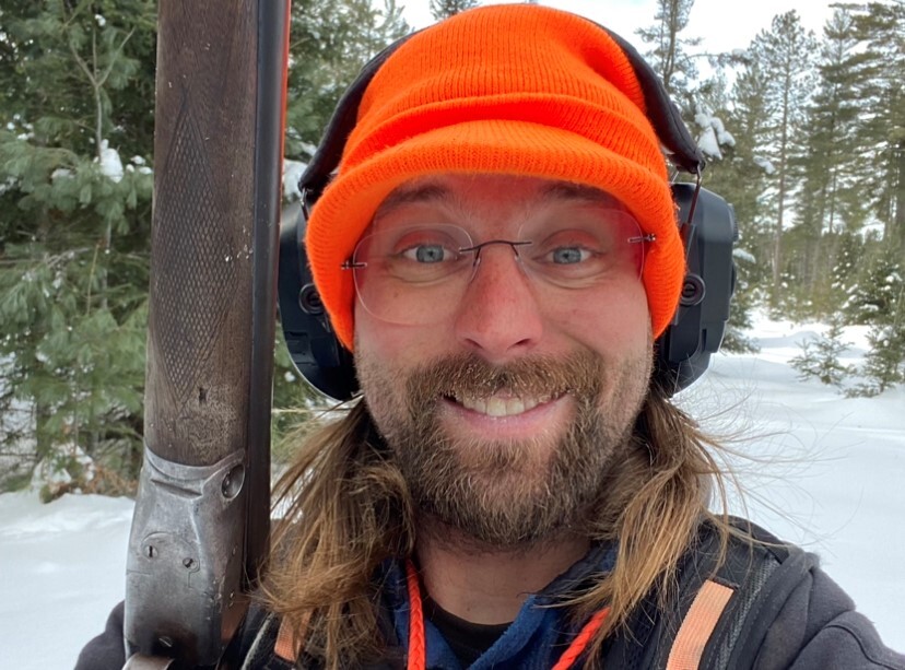 Colter Luben smiles for the camera while on a snowshoe hare hunt in the Upper Peninsula.