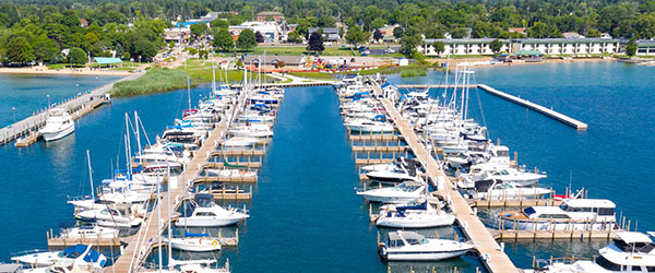 boats parked in harbor with harbor facility in background