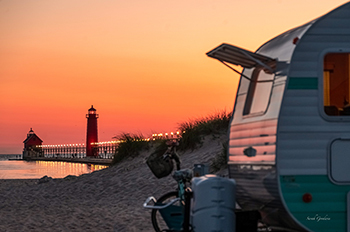 camper with lighthouse in the background