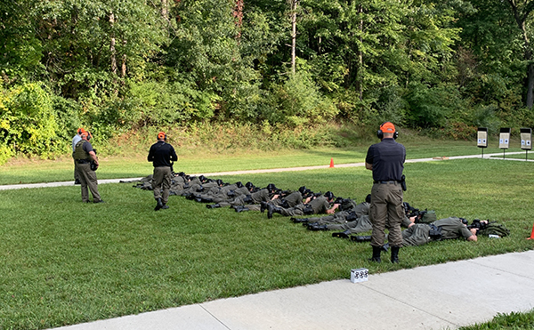 officers lay on the ground target shooting