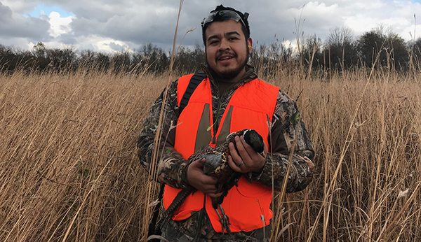 hunter holding harvested pheasant