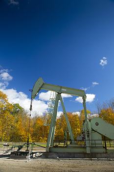 oil drilling equipment with fall forest in background