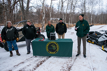 Speakers stand ready to make remarks at a trail reopening ceremony today.