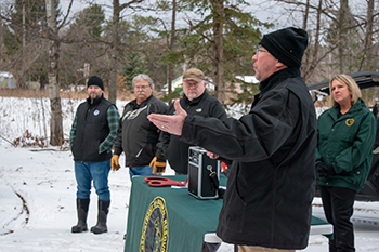 A DNR trails official speaks to attendees at today's ceremony.
