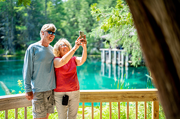 a couple taking a selfie from raft