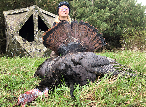 young hunter with harvested spring turkey