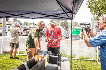 A researcher explains the tagging and tracking process to a bass angler.