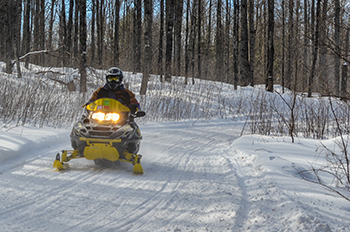 A snowmobiler enjoys a trip riding right on a winter morning in Gogebic County.
