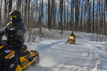 Snowmobilers enjoy a trip riding right on a winter morning in Gogebic County.