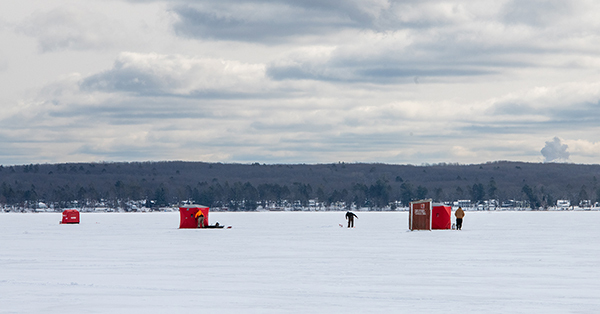 ice fishing shanties on frozen lake