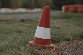 orange construction cone in grass