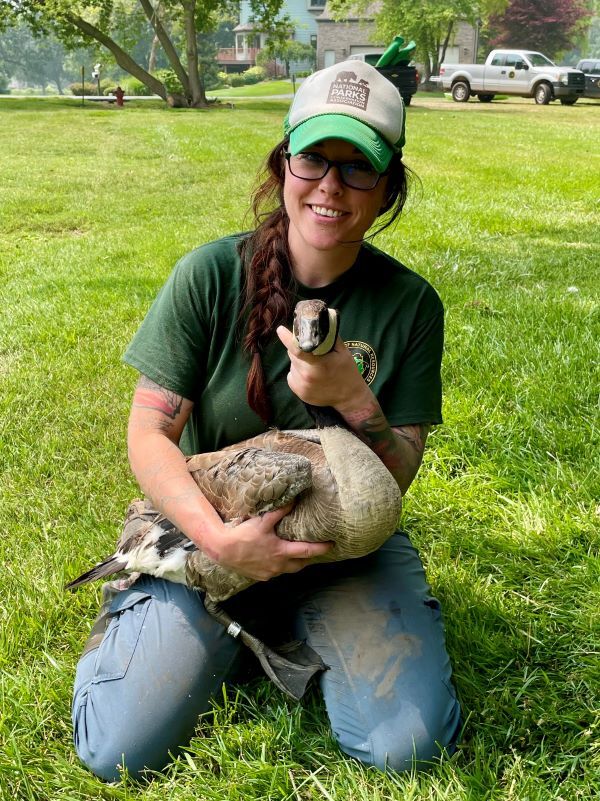 Samantha Greenlee smiles for the camera while holding a Canada goose.