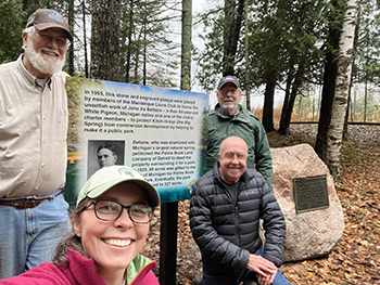 Members of the local Lions Club and the DNR's Theresa Neal shown at the new Bellaire display board.