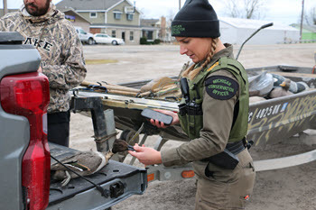 conservation officer holding a duck beak