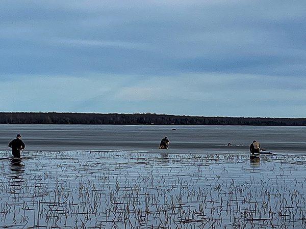 Rescuers work to save a man fallen through the ice of Lake Gogebic.