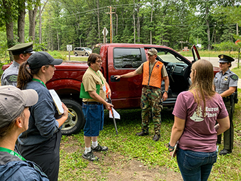 Participants, instructors and students are shown at a mock crime scene on location.