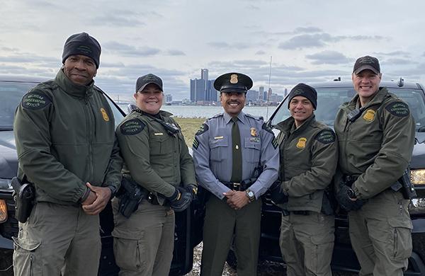 five officers smiling outside