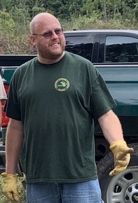 Greg Hochstetler smiles amidst habitat work. 