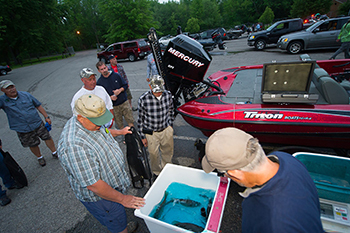 Fishing tournament participants weighing their catch