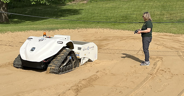 DNR staff member controlling BeBot beach-cleaning robot