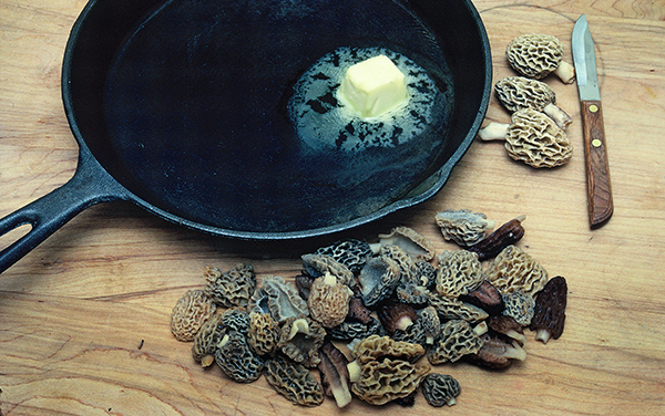 morel mushrooms next to pan with butter melting