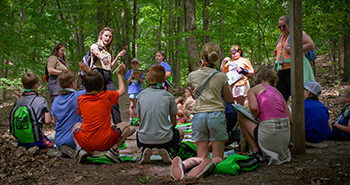 An interpreter engages children on a Nature Awaits outing at P.J. Hoffmaster State Park.