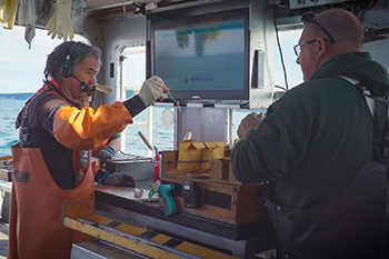 Fisheries researchers are shown on a Great Lakes vessel.